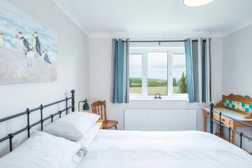 a bedroom with two beds and a window at The Willows Dinas Cross in Newport