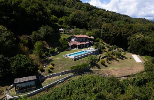 an aerial view of a house on a hill with a swimming pool at Villa Valentina by Rent All Como in Civenna