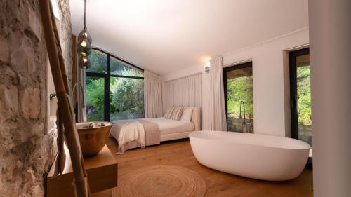 a bathroom with a large tub and a bedroom at Villa Valentina by Rent All Como in Civenna
