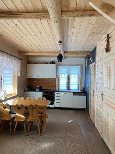 a kitchen with a table and chairs in a room at U Borowiczów in Białka Tatrzańska