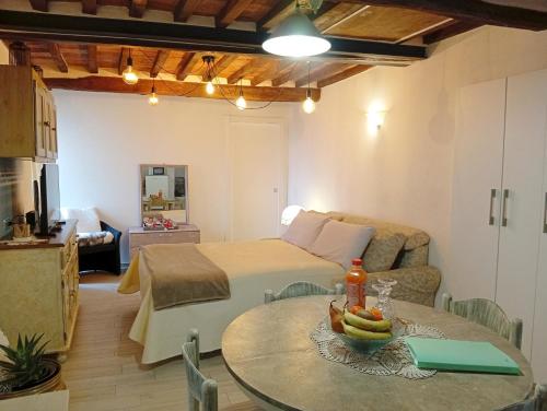 a living room with a bed and a table at Casa Giovy in Roccastrada