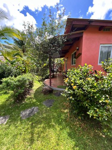 a house with a walkway in front of a yard at Cabanas Los Colibris Hotel Ecolodge in San Carlos