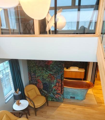 a view of a room with a tub and a chair at Pinnacle Suites Hotel in Cowes