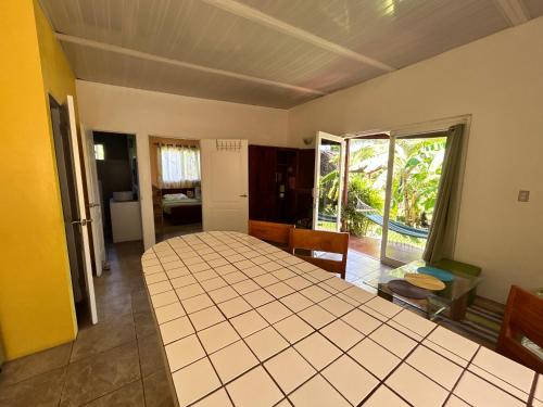 a room with a large table in a room at Cabanas Los Colibris Hotel Ecolodge in San Carlos