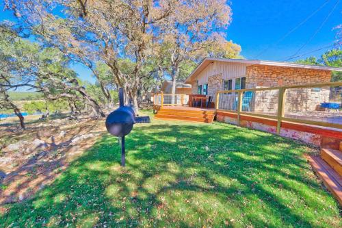 a house with a yard with a bird house at Millies Cottages Unit 2 - Annie in Canyon Lake