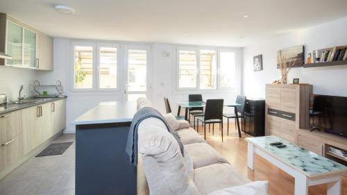 a kitchen and living room with a couch and a table at AG Piso Fogar Carballo, 3 habitaciones in Carballo