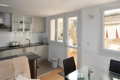 a kitchen with a table and a dining room at AG Piso Fogar Carballo, 3 habitaciones in Carballo