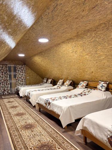 a group of four beds in a room at Cabana CORNESTEAN in Sighetu Marmaţiei