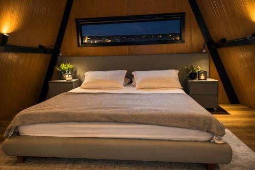 a bedroom with a large bed with a window at Cabana Industrial in Palhoça
