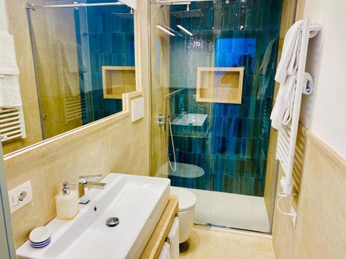 a bathroom with a sink and a shower and a toilet at Rooftop luxury apartment in Capri