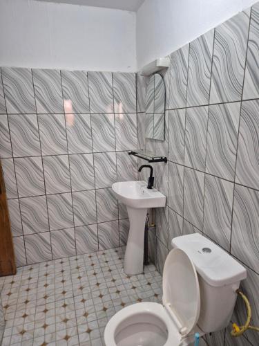 a bathroom with a toilet and a sink at G and E Guesthouse in Kumba