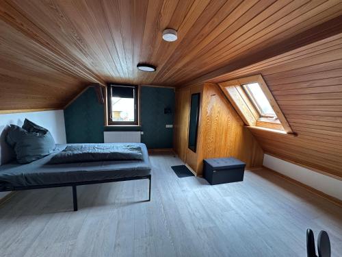 a bedroom with a bed in a room with wooden ceilings at Good N8 Apartment in Wabern