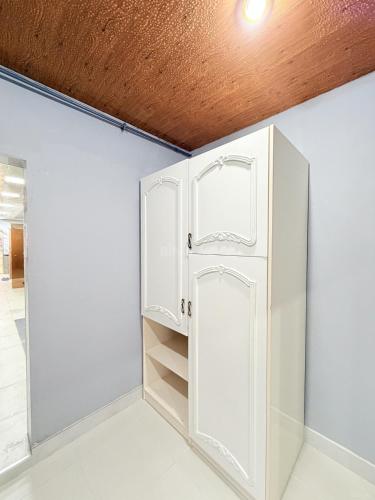 a white closet with a door in a room at Novxanı Villa in Baku