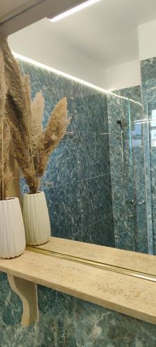 a bathroom with a bench with a mirror and a shower at a&bpikermistudios4 in Pikérmion