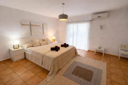 a bedroom with a large bed and a large window at Can Catalina in Can Furnet