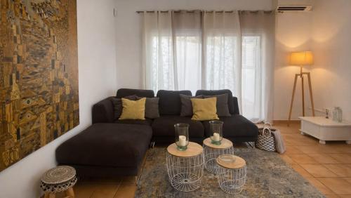 a living room with a couch and two tables at Can Catalina in Can Furnet