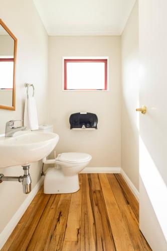 a bathroom with a toilet and a sink at Omori Lodge in Tokaanu