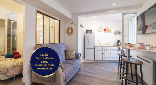 a kitchen with a blue chair with a sign on it at Escapade studio centre ville Rodez in Rodez