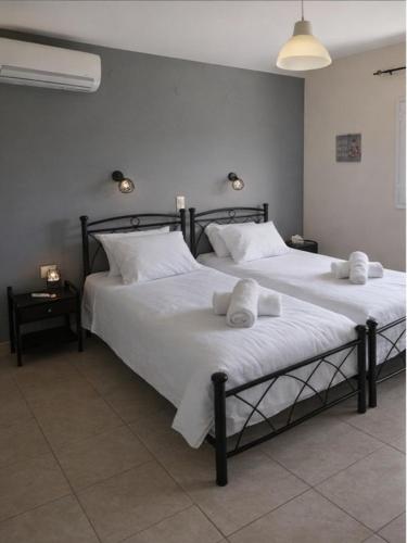 a bedroom with two beds with towels on them at Rodanthy I in Katelios
