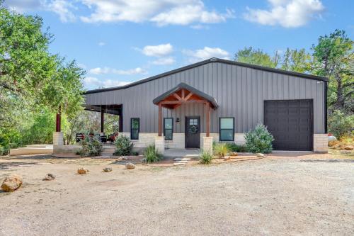 a large metal building with a garage at Barndo on the Blanco in Wimberley