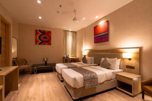 a hotel room with two beds in a room at Hotel Bluestone Prime Nehru Place by The Cosy hotels in New Delhi