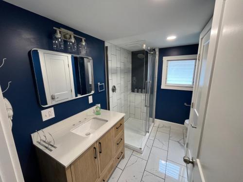 a bathroom with a sink and a shower at Wally’s Matchbox |New|Hot Tub|Fire Pit|Close 2 All in Hawley
