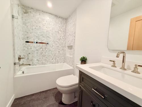 a bathroom with a toilet and a tub and a sink at Private Hillside 2BR Suite Near Town in Ojai