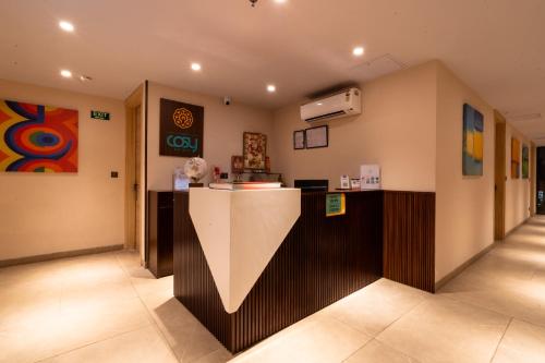 a restaurant with a counter in the middle of a room at Hotel Bluestone Prime Nehru Place by The Cosy hotels in New Delhi