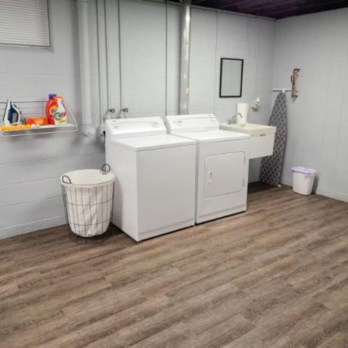 a bathroom with two washing machines and a sink at Potter Cottage - Beautiful Serene Setting in Ferdinand