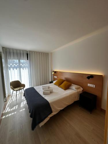 a bedroom with a large bed and a chair at AT home Santo Domingo in Guadalajara