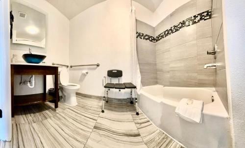 a bathroom with a tub and a toilet and a sink at Clarion Pointe in Charlotte