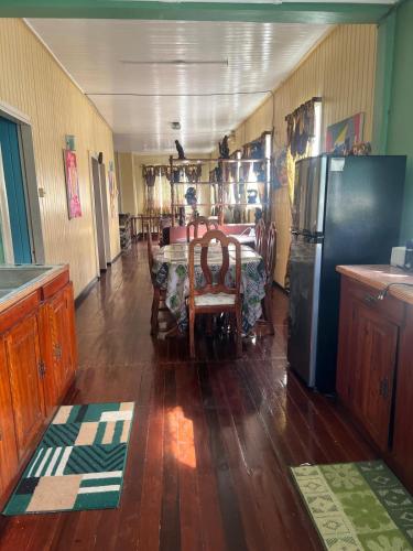 a dining room with a table and a refrigerator at Arlington Apartments in Georgetown