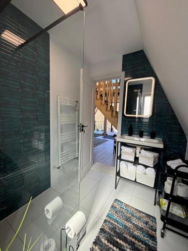 a bathroom with a shower and a sink and a mirror at NOOR A-frame Sibiu in Gura Râului