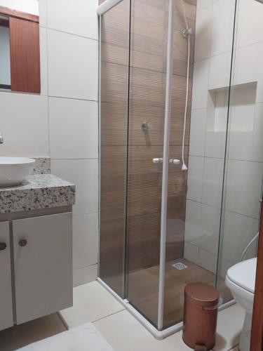 a shower with a glass door in a bathroom at Bem Estar no Bom Ap 1 in Arapiraca