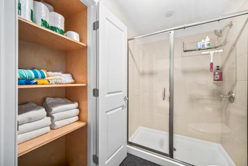 a bathroom with a glass shower stall and towels at Hampton Beach OCEAN FRONT Condo at the Surf in Hampton