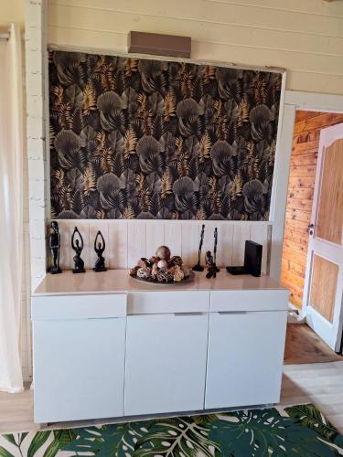 a kitchen with a counter with a wall at Chalet Horizon Mer in Conca