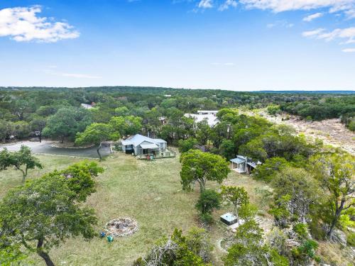 an aerial view of a house with a yard and trees at Bungalow on the Bluff in Fischer