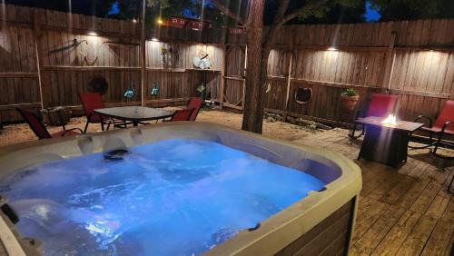 a hot tub in a yard with a table and chairs at Bungalows on the Square- Unit 1 in Wimberley