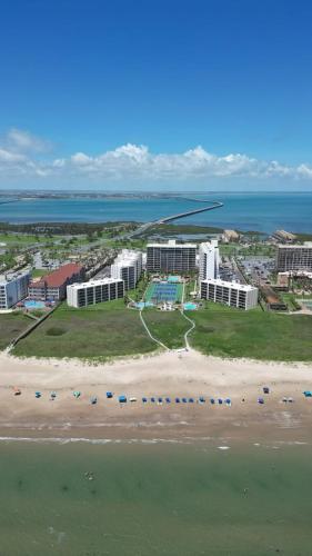 an aerial view of a beach with buildings and the ocean at 12th Floor Penthouse Beachfront, Large Balcony, Amazing Views, 3 Pools, Tennis in South Padre Island