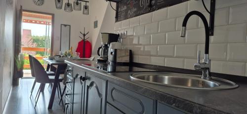a kitchen with a sink and a counter top at Bike & Chill Apartment in Balatonfüred