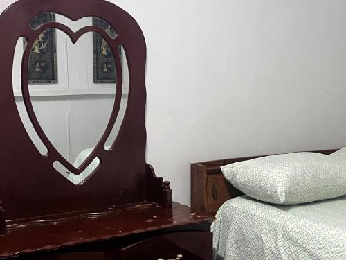 a bedroom with a heart shaped mirror next to a bed at Arlington Apartments in Georgetown