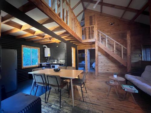 a kitchen and dining room with a table and chairs at Pangui Lodge in Las Trancas