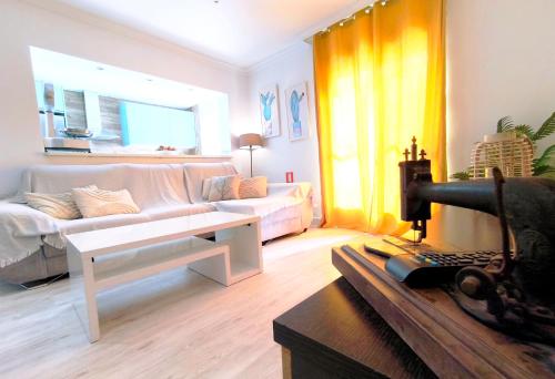 a living room with a couch and a table at Apartamento Lances playa tarifa in Tarifa