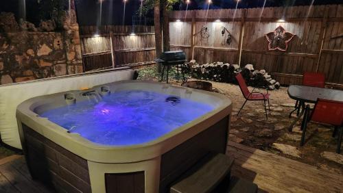 a hot tub in a room with a table and chairs at Bungalows on the Square- Unit 1 in Wimberley