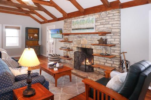 a living room with a fireplace and a blue couch at Burnett Ranch Cabins- Prickly Pear in Wimberley