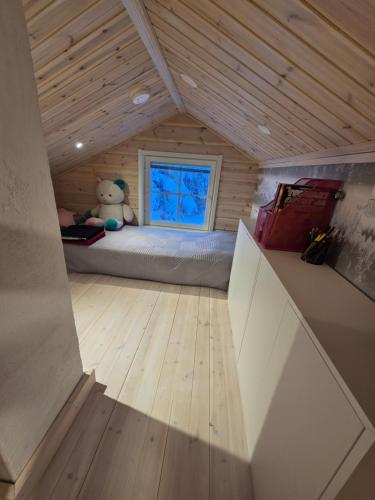 a small room with a bed and a teddy bear at Villa lehto in Kuusamo