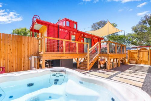 a house with a bath tub in front of a house at Caboose on the Square in Wimberley