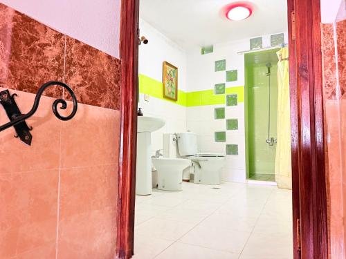 a bathroom with two toilets and a door at Casa Olea Vista in Chefchaouen