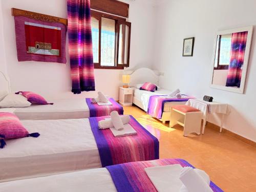 a room with three beds with crosses on them at Casa Olea Vista in Chefchaouen