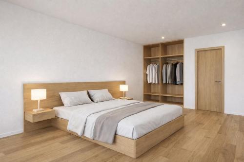 a bedroom with a large bed with two lamps at Chalet Villa Hera in Bichlbach